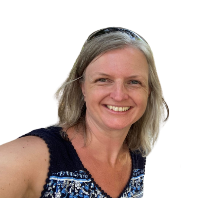 A woman with shoulder-length blonde hair smiles at the camera. She is wearing a sleeveless patterned top and sunglasses on her head. The background is transparent. Designed by Circular Design, a not-for-profit web design agency.