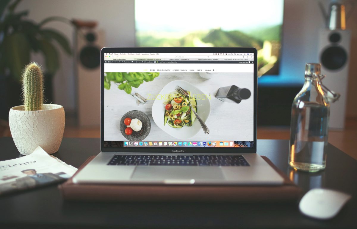 A laptop sitting on a desk representing the process of building a website.